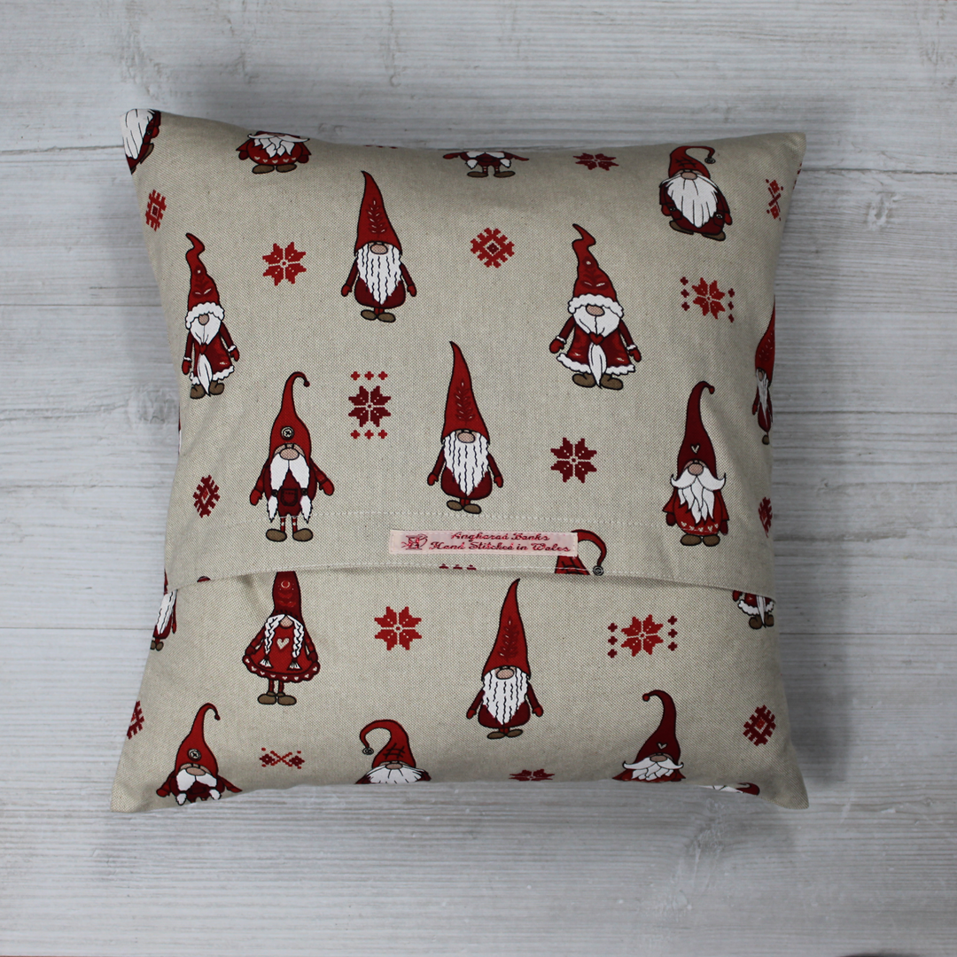 Cushion with multiple Red gnomes on a linen look fabric