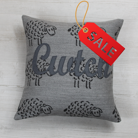 Cwtch Cushion on a beautiful grey tapestry style fabric 